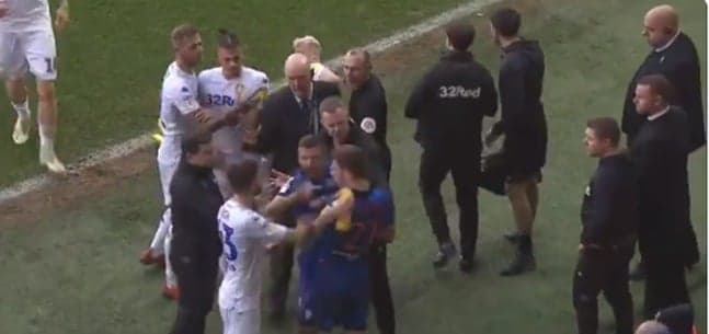 Leeds United’s Mateusz Klich squirts water down opponent’s back during melee Leeds United’s Mateusz Klich squirts water down opponent’s back during melee