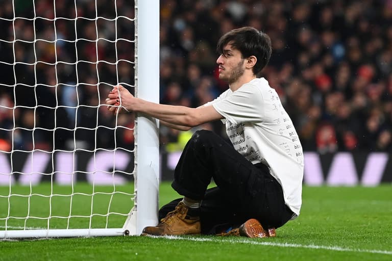 Environmental activist tries to handcuff himself to goal during Arsenal vs Liverpool clash Environmental activist tries to handcuff himself to goal during Arsenal vs Liverpool clash